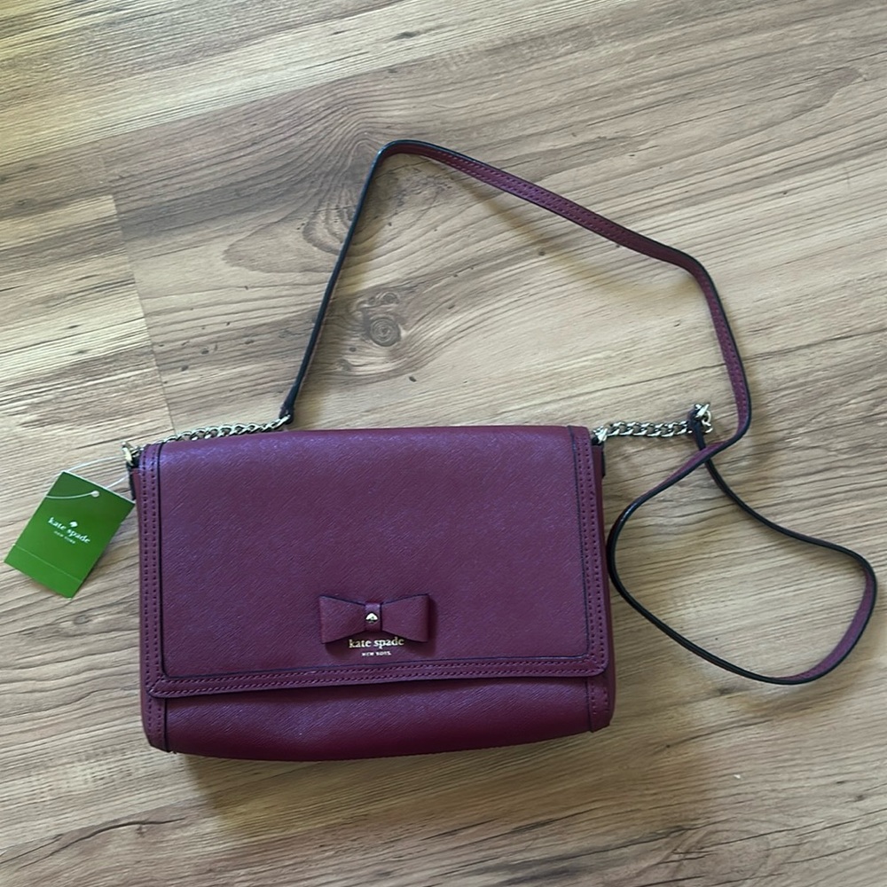 Kate Spade crossbody bag. Maroon color with bow and chain detailing